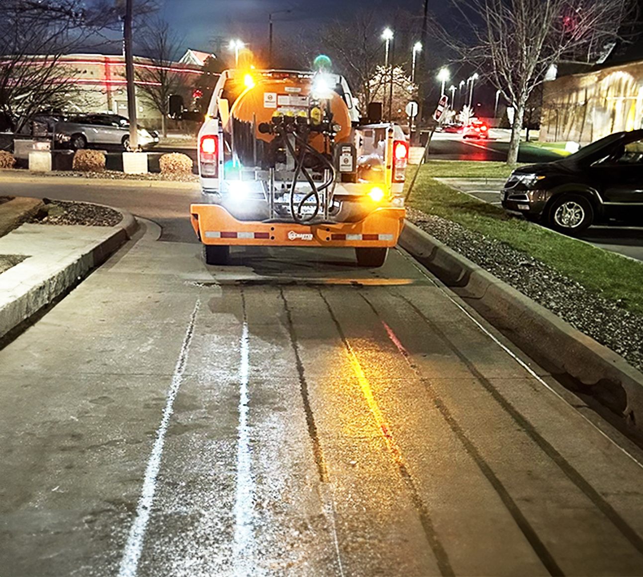 Liquid salt truck deicing roadway to prepare for midwest snow and ice storm